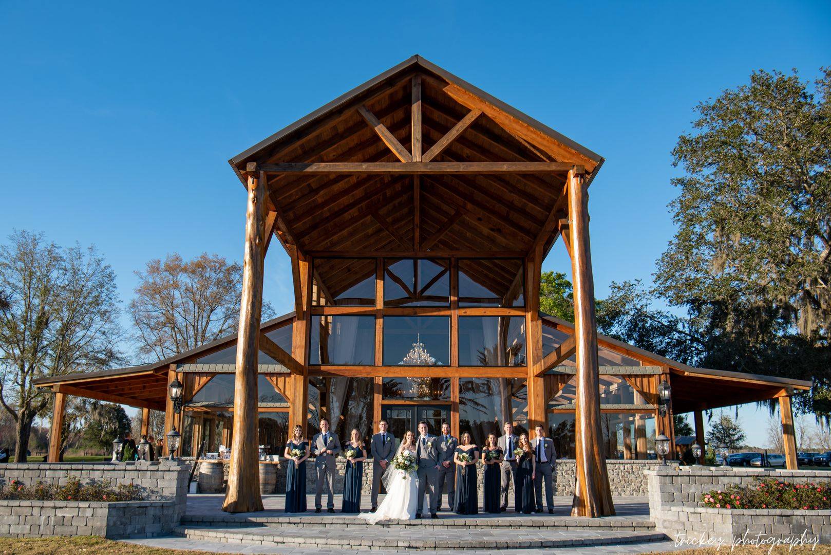 Wedding party in front of the timber-frame entrance of The Barn at Cottonwood Ranch