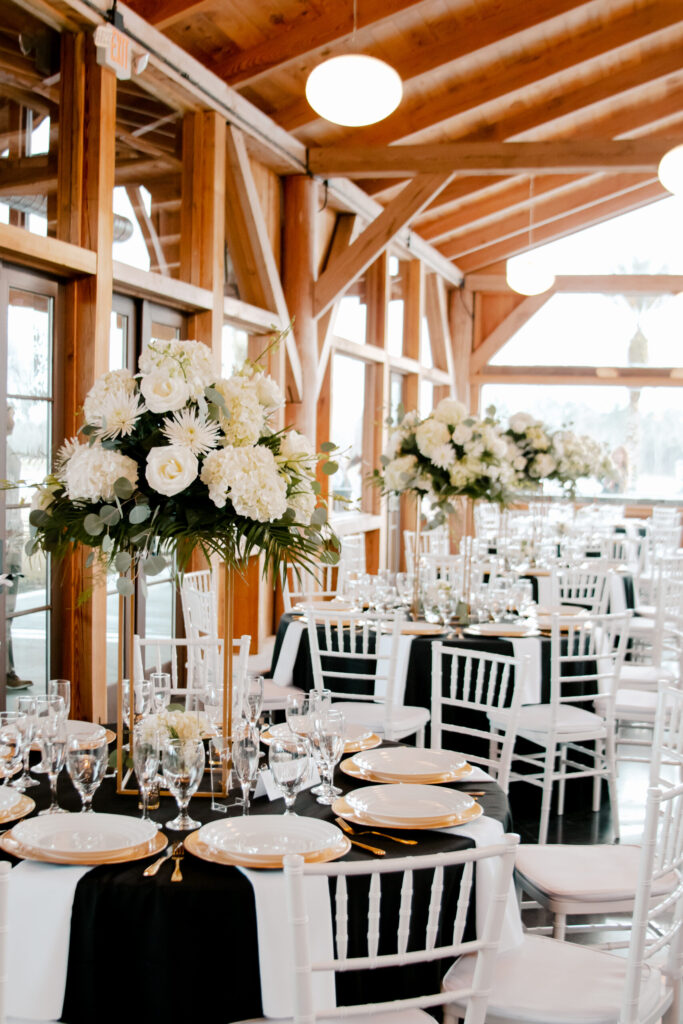 Tall white floral centerpieces on reception tables at The Barn at Cottonwood Ranch