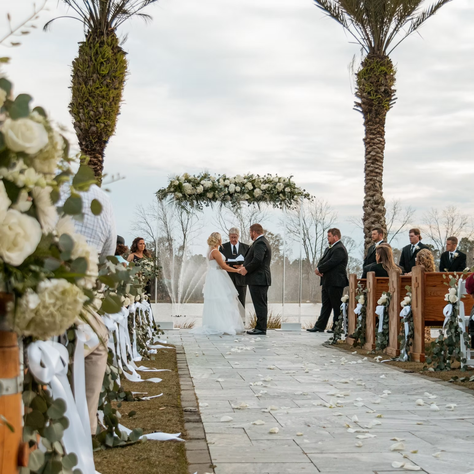 Outdoor wedding ceremony aisle with palm trees at The Barn at Cottonwood Ranch