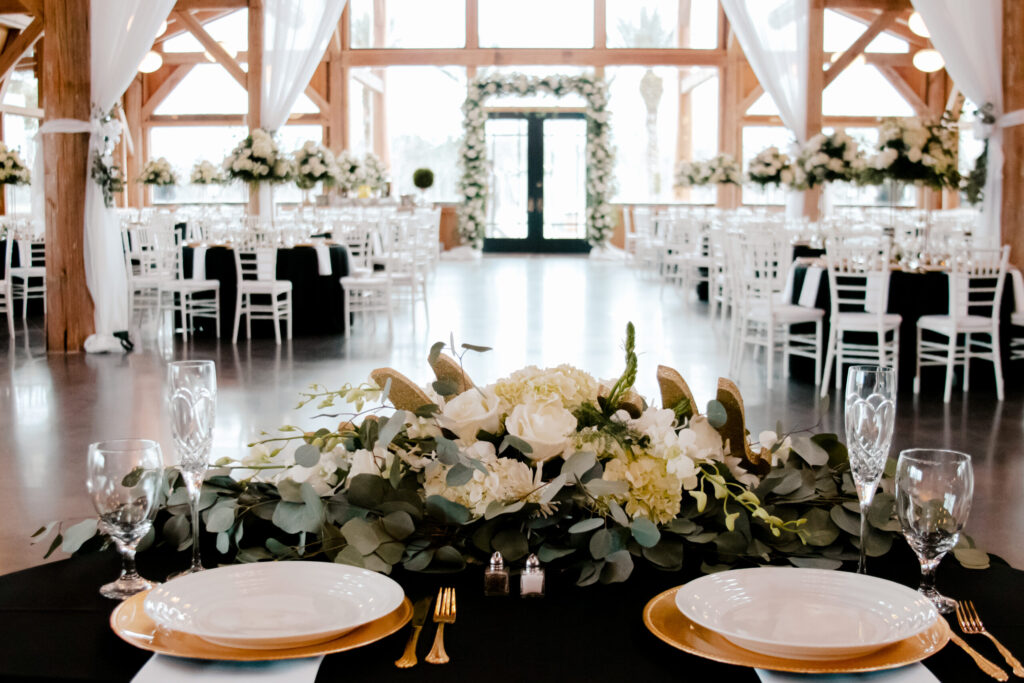 Floral head table set for a wedding reception in the main hall