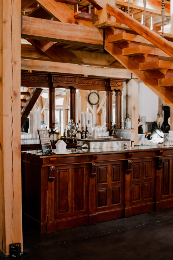 Wood bar beneath the staircase inside The Barn at Cottonwood Ranch