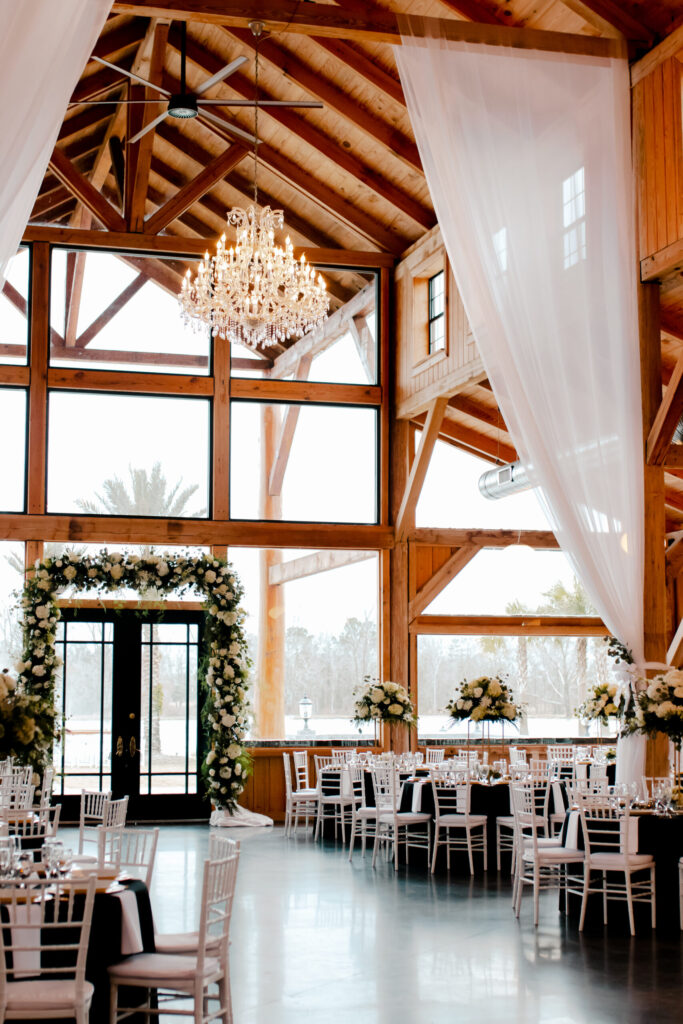 Chandelier and draped timber beams above reception tables in the main hall
