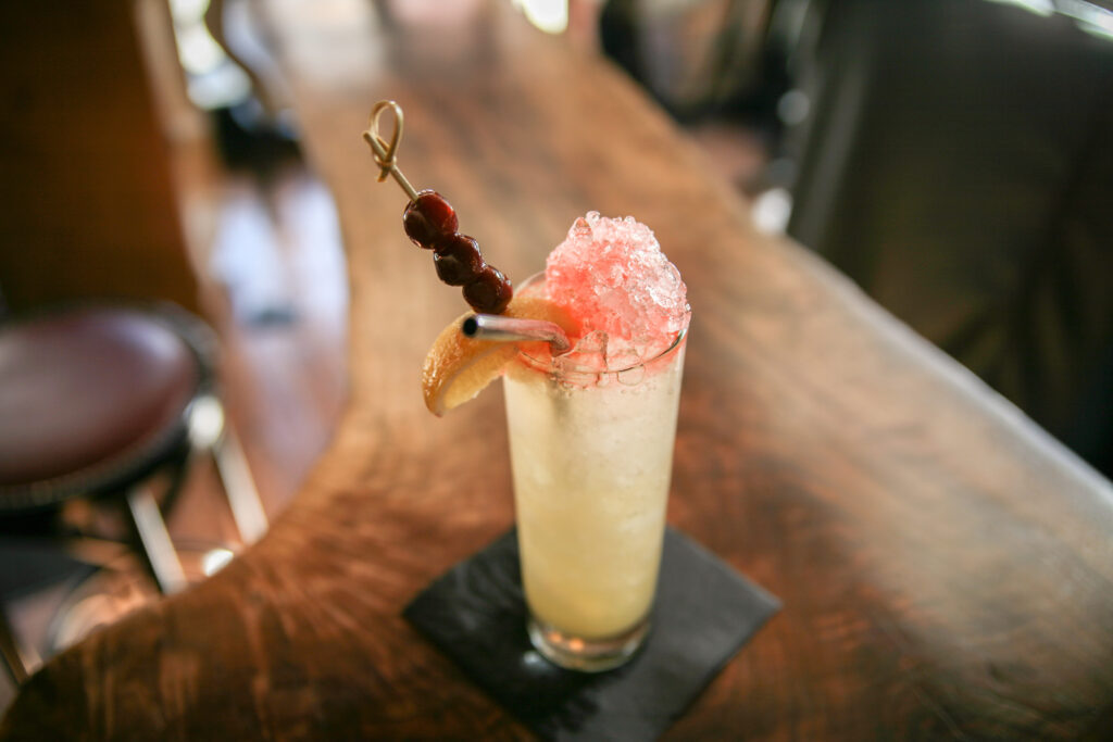 Garnished cocktail on the wood bar at The Barn at Cottonwood Ranch