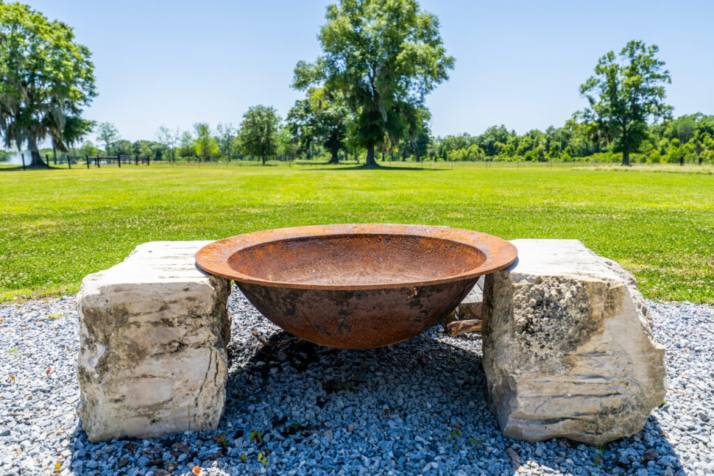 Stone fire bowl overlooking the pastures at Cottonwood Ranch