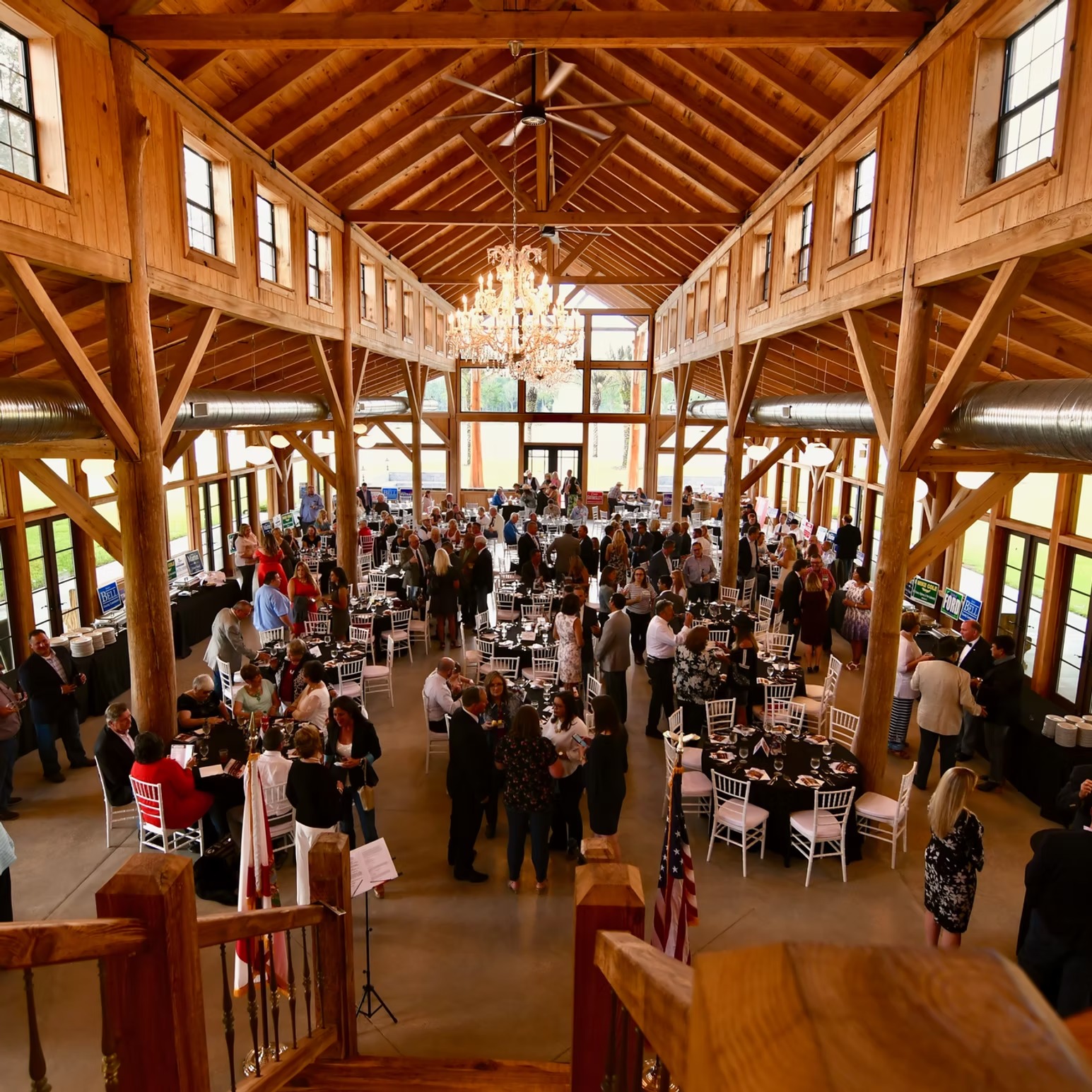 Guests at a wedding reception in the main hall, viewed from the loft