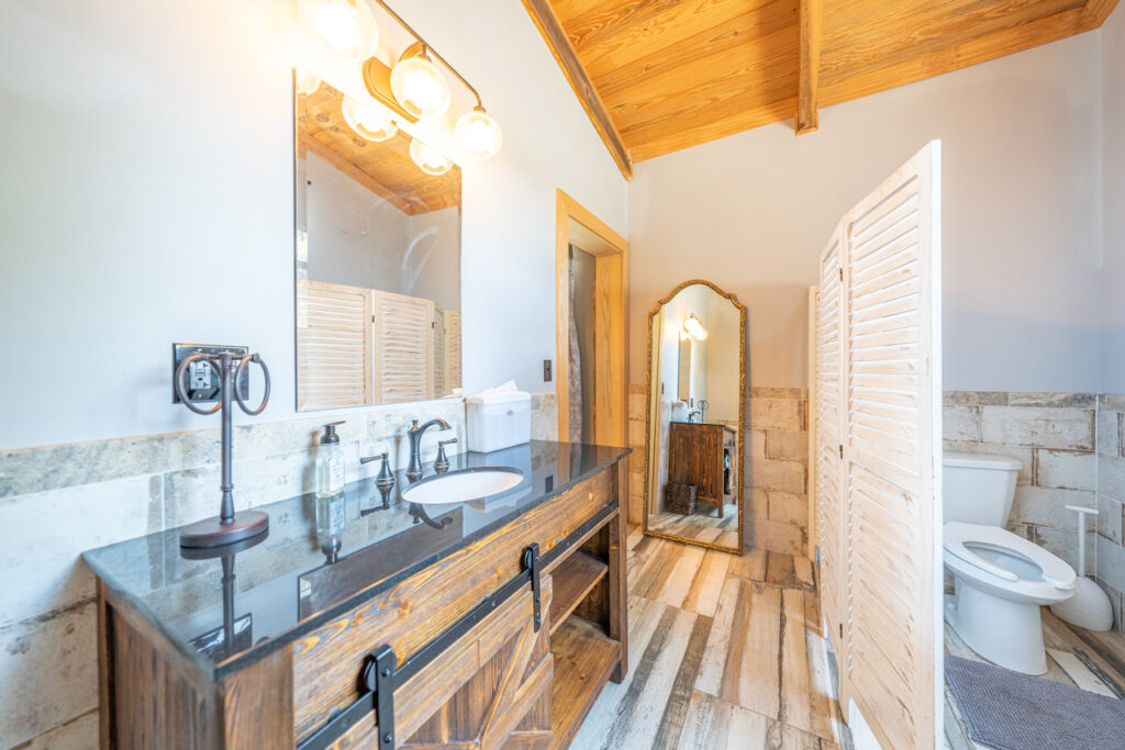 Suite bathroom with wood vanity at The Barn at Cottonwood Ranch