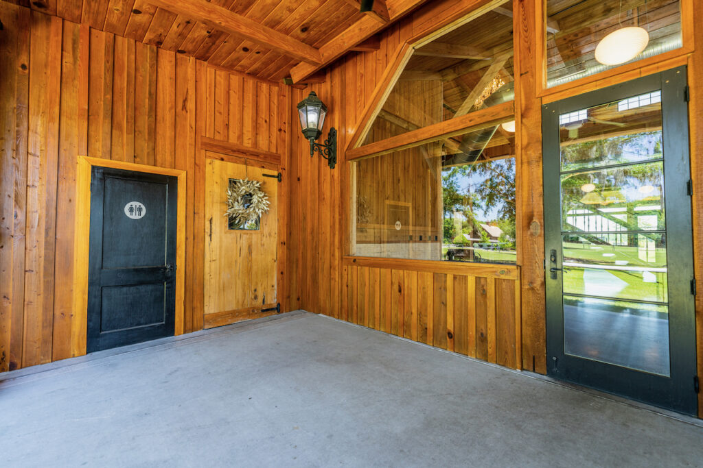 Covered porch entrance with wood siding at Cottonwood Ranch
