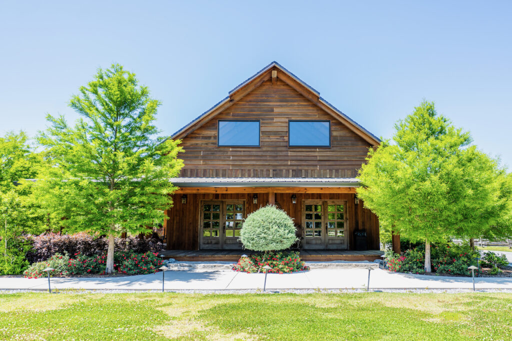 Wood-sided lodge exterior and lawn at Cottonwood Ranch