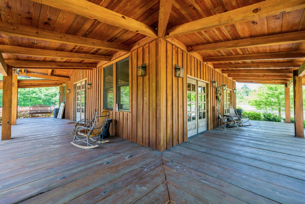 Wraparound covered porch with rocking chairs at Cottonwood Ranch