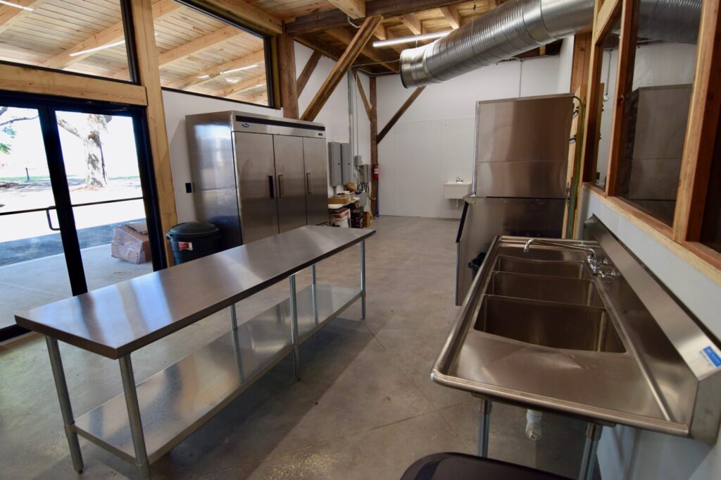Commercial catering kitchen with stainless steel prep tables