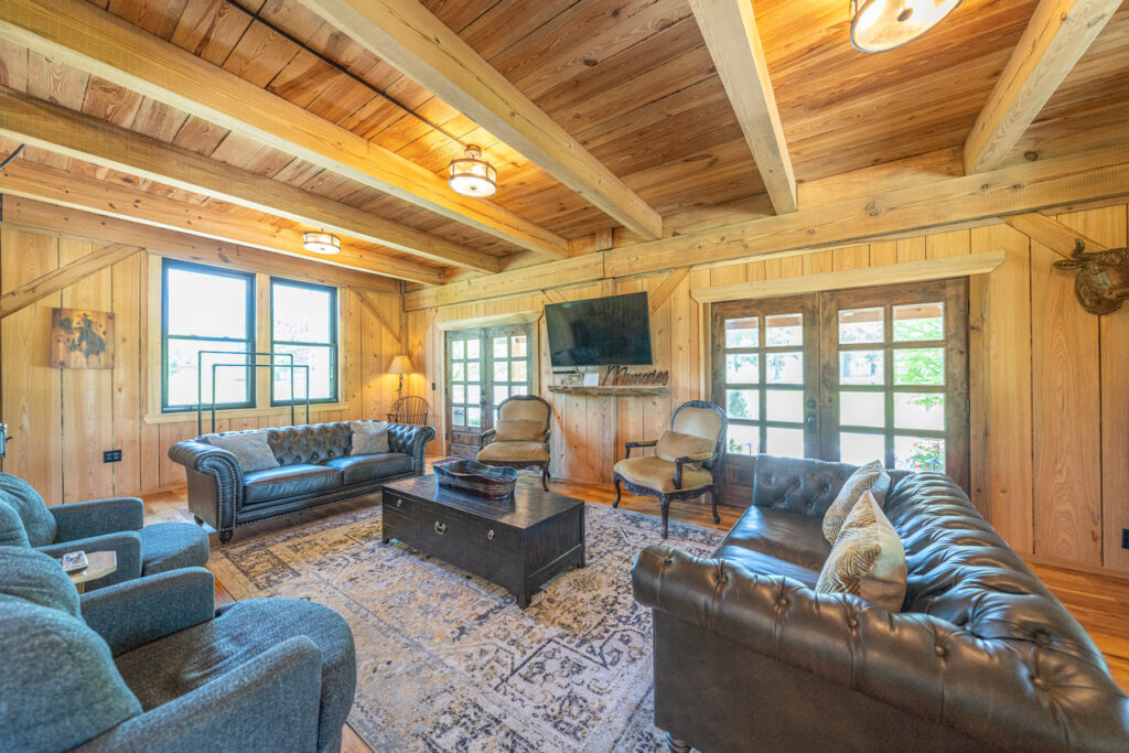 Lounge with leather sofas and wood ceilings at The Barn at Cottonwood Ranch